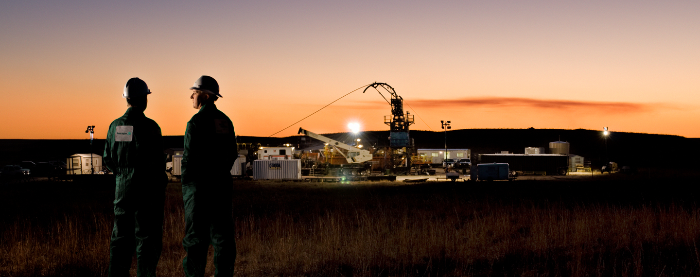 Two Baker Hughes employees at a coiled-tubing rig site