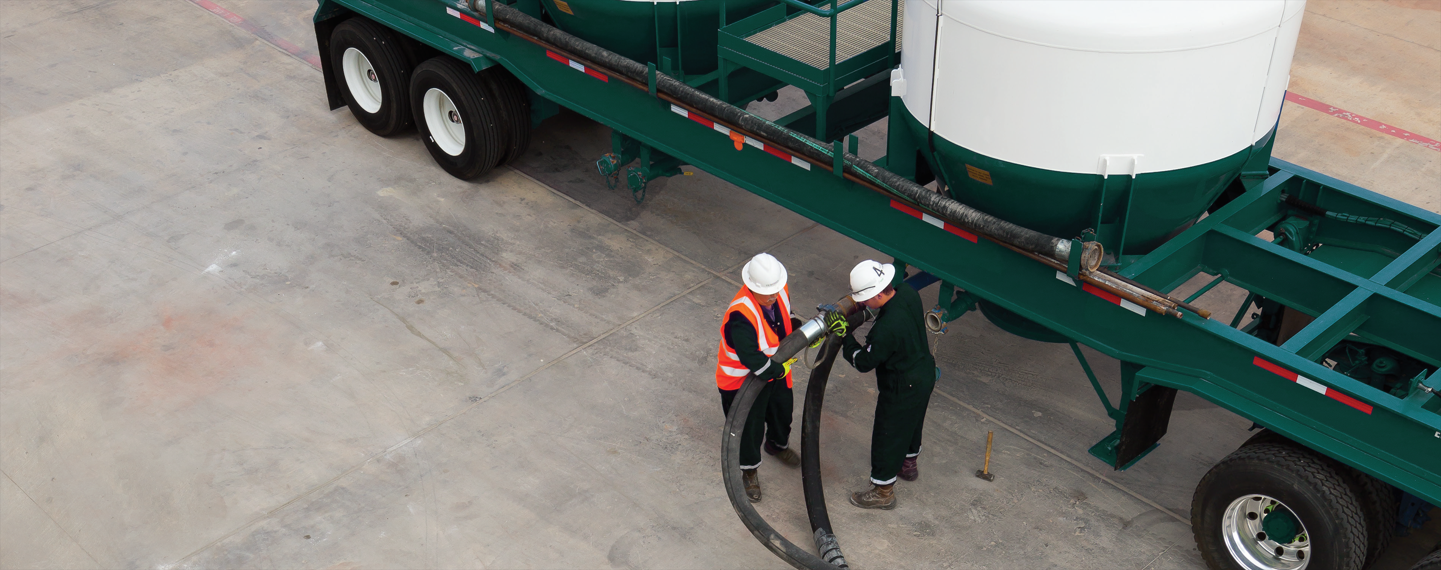 Photo of Baker Hughes employees deploying Set for Life cementing system