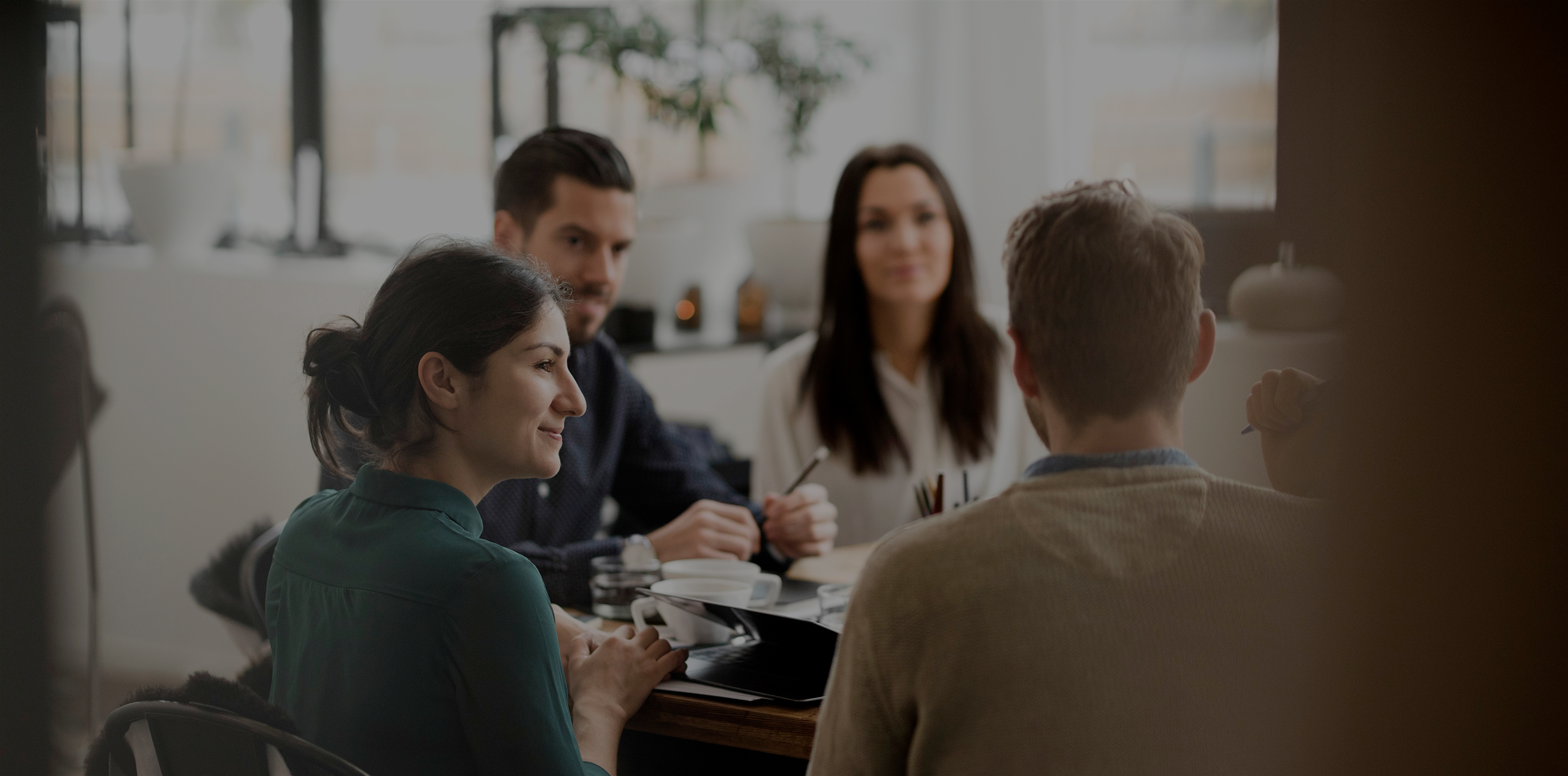 Group of people in an office having a meeting.