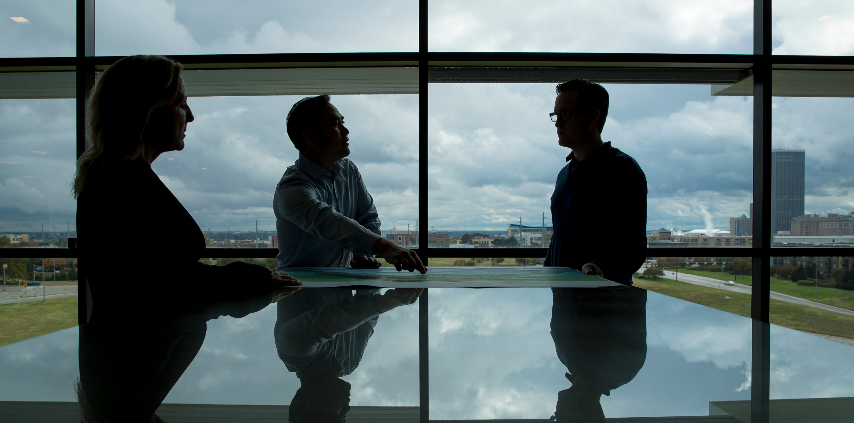 Photo of people standing in front of a window.