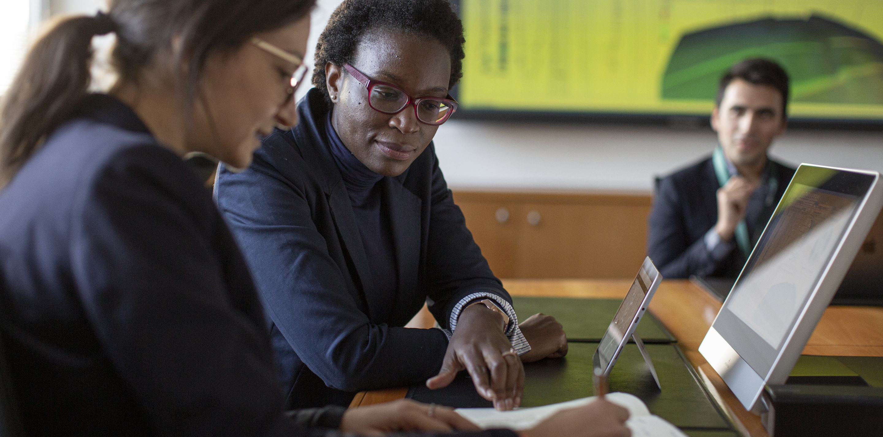 People collaborating at a computer screen.