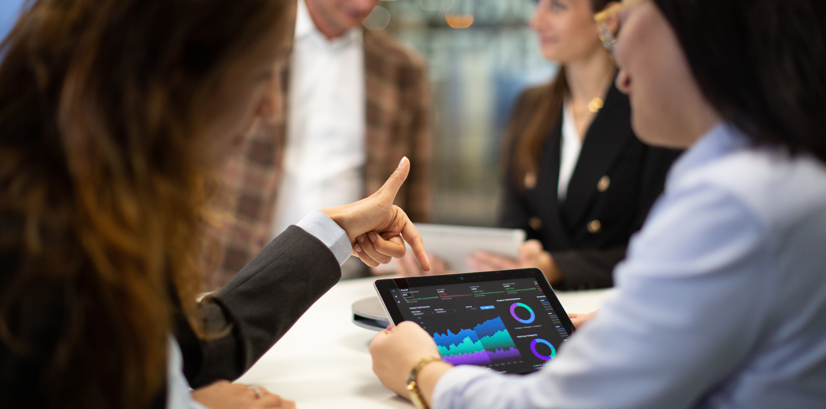 People collaborating around an ipad.