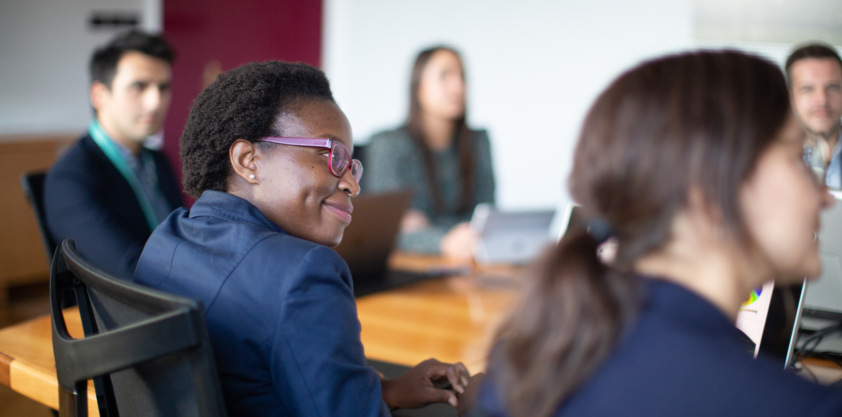 People in a meeting sitting around a table.