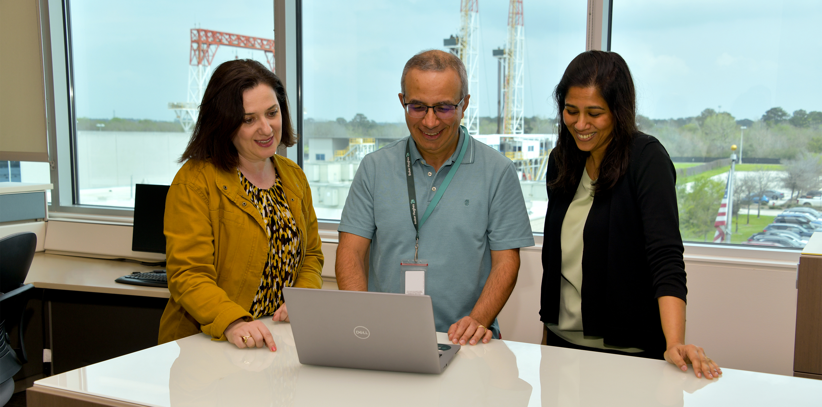 People collaborating around a laptop.