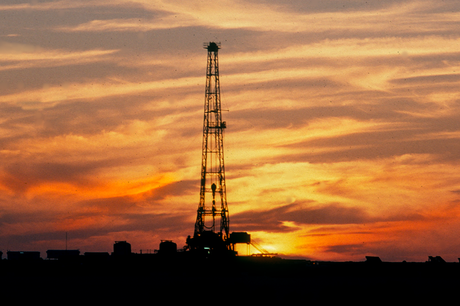 Photo of a land rig at sunset.