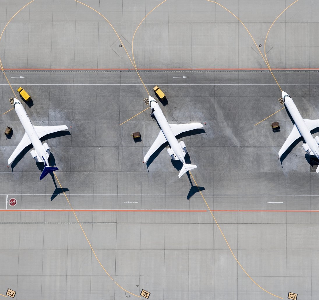 three airplanes lined up to be inspected