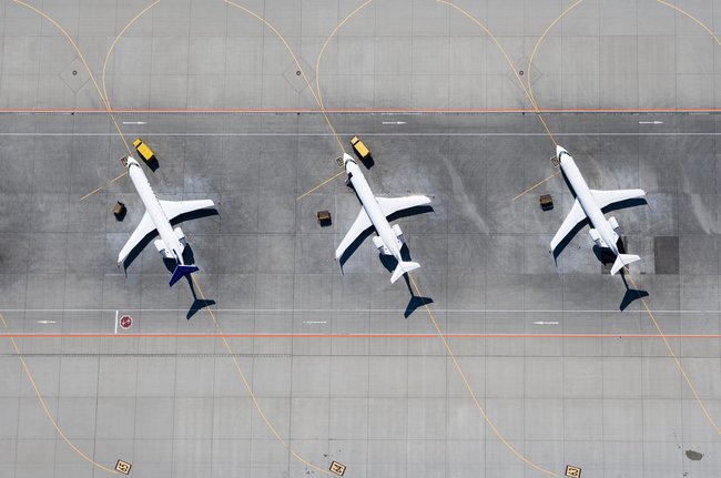 three airplanes lined up to be inspected