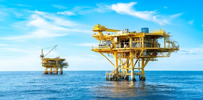 Photo of two offshore production rigs.