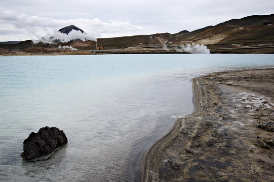 Mountainousland with a well and a huge bed of sea beside it 