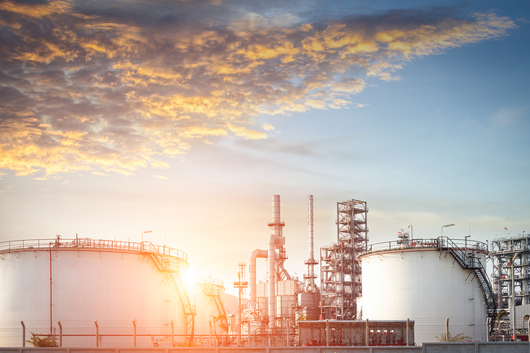 Distant view of a refinery plant during sunset