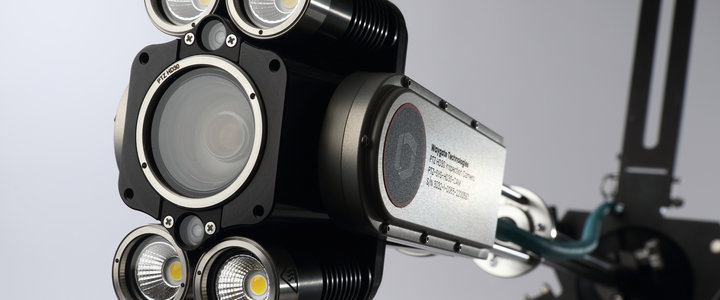 Close up image of ca-zoom hd ptz inspection camera head extended and held up by its industrial mount that attaches to the outside of the vessel access point.